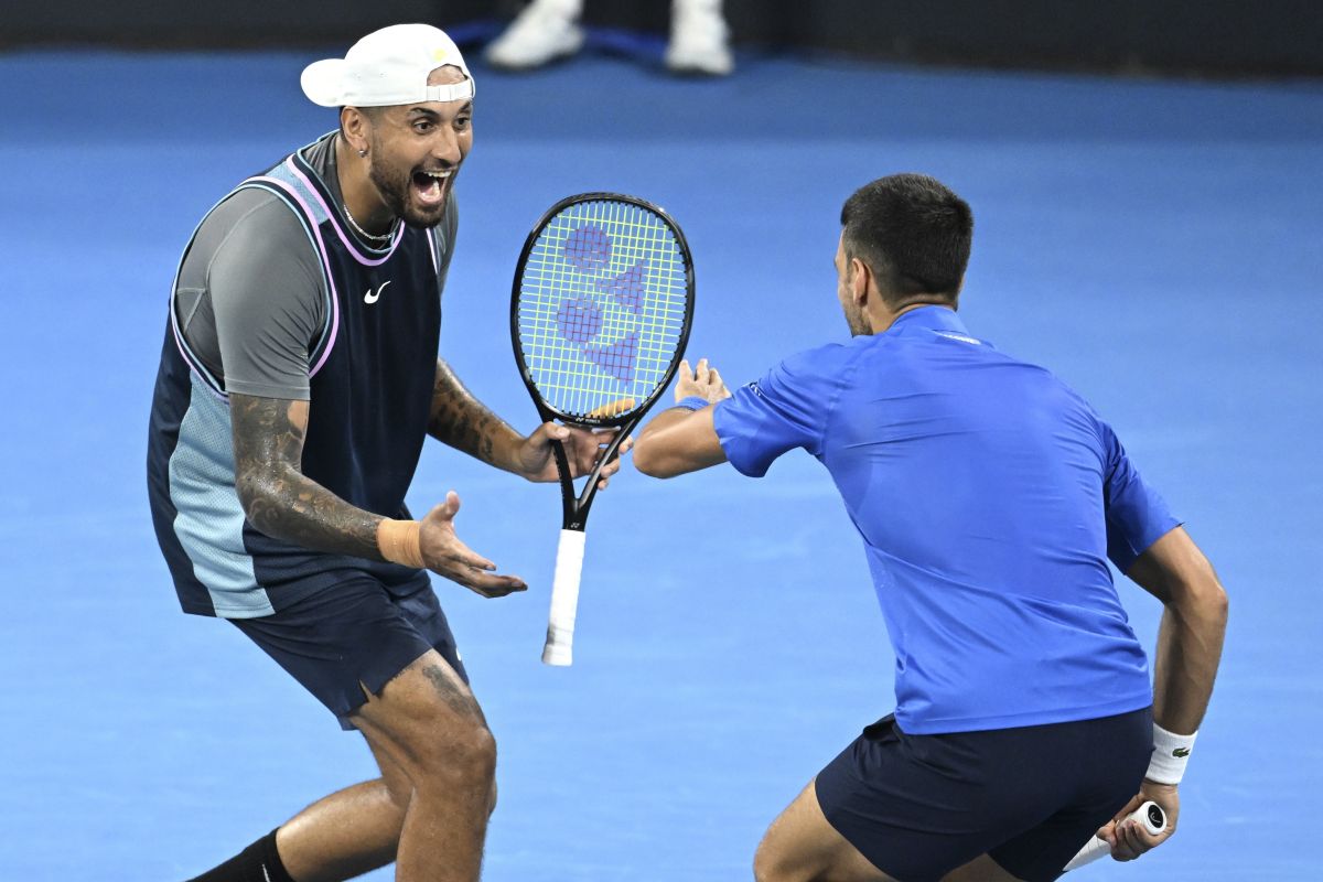 Australia's Nick Kyrgios, left, and Serbia's Novak Djokovic celebrate during their doubles match against Alexander Erler of Austria and Andreas Mies of Germany in the Brisbane International, at the Queensland Tennis Centre in Brisbane, Australia, Monday, Dec. 30, 2024. (Darren England/AAP Image via AP)