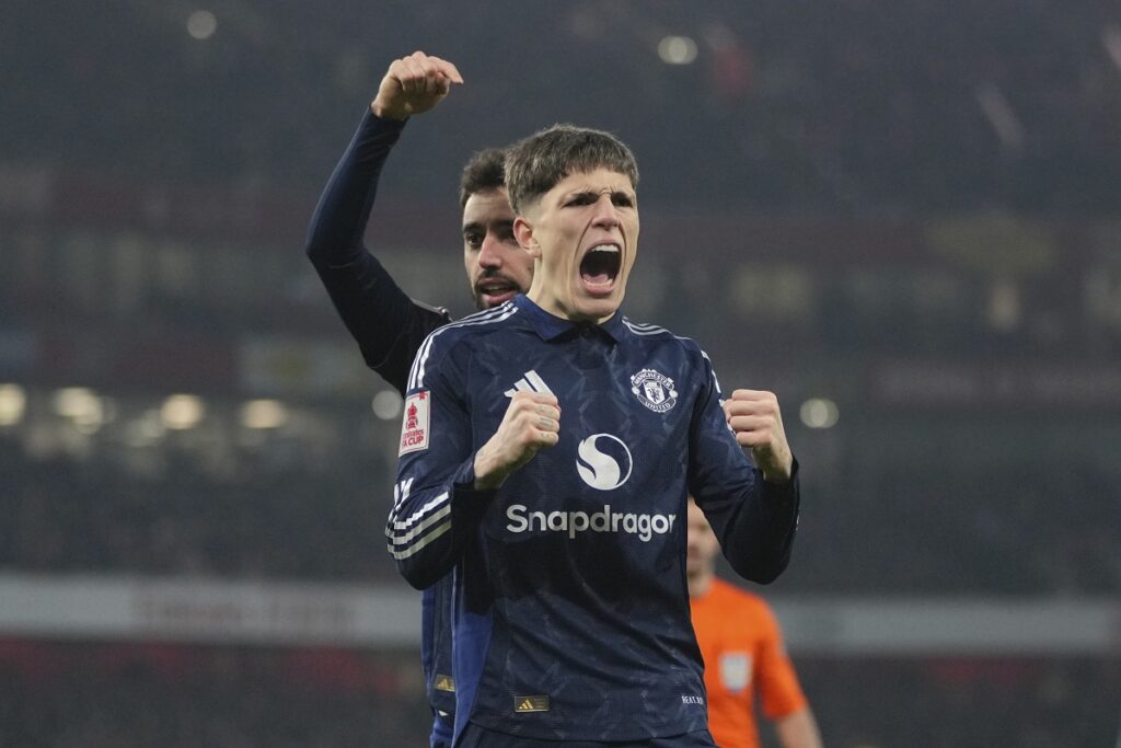 Manchester United's Bruno Fernandes, left, celebrates with his teammate Alejandro Garnacho after scoring his side's opening goal during the English FA Cup soccer match between Arsenal and Manchester United at the Emirates stadium in London, Sunday, Jan. 12, 2025. (AP Photo/Kin Cheung)