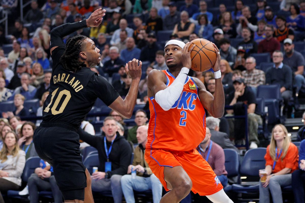 Oklahoma City Thunder guard Shai Gilgeous-Alexander (2) looks to shoot against Cleveland Cavaliers guard Darius Garland (10) during the first half of an NBA basketball game, Thursday, Jan. 16, 2025, in Oklahoma City. (AP Photo/Nate Billings)