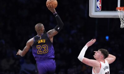 Los Angeles Lakers forward LeBron James, left, shoots as Portland Trail Blazers center Donovan Clingan defends during the second half of an NBA basketball game, Thursday, Jan. 2, 2025, in Los Angeles. (AP Photo/Mark J. Terrill)