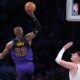 Los Angeles Lakers forward LeBron James, left, shoots as Portland Trail Blazers center Donovan Clingan defends during the second half of an NBA basketball game, Thursday, Jan. 2, 2025, in Los Angeles. (AP Photo/Mark J. Terrill)