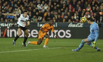 Valencia's goalkeeper Stole Dimitrievski, right, stops a ball to Real Madrid's Vinicius Junior during a Spanish La Liga soccer match at Mestalla stadium in Valencia, Spain, Friday, Jan. 3, 2025. (AP Photo/Alberto Saiz)