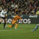 Valencia's goalkeeper Stole Dimitrievski, right, stops a ball to Real Madrid's Vinicius Junior during a Spanish La Liga soccer match at Mestalla stadium in Valencia, Spain, Friday, Jan. 3, 2025. (AP Photo/Alberto Saiz)