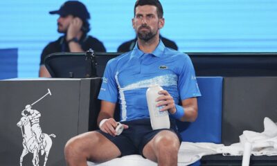 Serbia's Novak Djokovic takes a drink during a break in his exhibition match against Germany's Alexander Zverev ahead of the Australian Open tennis championship in Melbourne, Australia, Thursday, Jan. 9, 2025. (AP Photo/Vincent Thian)