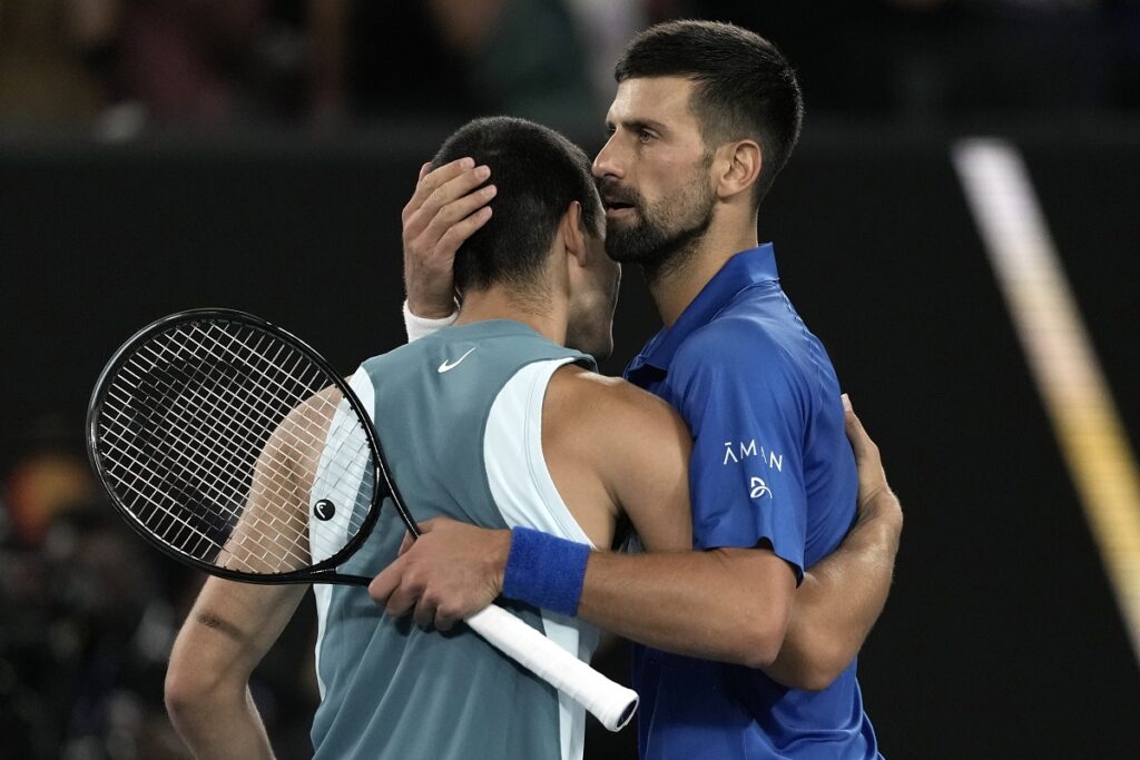 Novak Djokovic, right, of Serbia is congratulated by Carlos Alcaraz of Spain following their quarterfinal match at the Australian Open tennis championship in Melbourne, Australia, early Wednesday, Jan. 22, 2025. (AP Photo/Ng Han Guan)