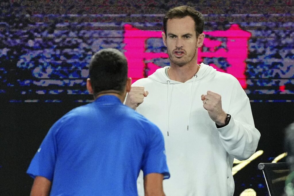 Andy Murray reacts with Novak Djokovic following his win over Carlos Alcaraz of Spain in their quarterfinal match at the Australian Open tennis championship in Melbourne, Australia, early Wednesday, Jan. 22, 2025. (AP Photo/Vincent Thian)