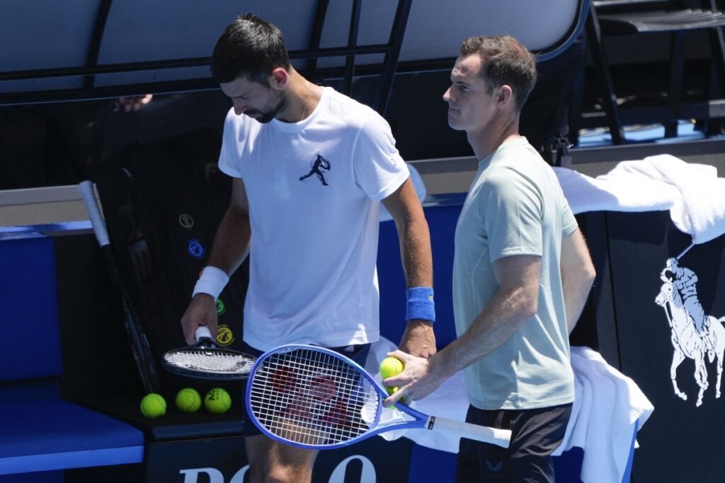 Serbia's Novak Djokovic walks with his coach Andy Murray, right, during a practice session ahead of the Australian Open tennis championship in Melbourne, Australia, Saturday, Jan. 11, 2025. (AP Photo/Ng Han Guan)