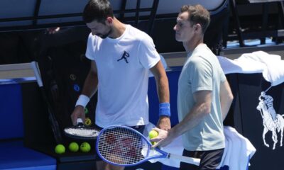 Serbia's Novak Djokovic walks with his coach Andy Murray, right, during a practice session ahead of the Australian Open tennis championship in Melbourne, Australia, Saturday, Jan. 11, 2025. (AP Photo/Ng Han Guan)