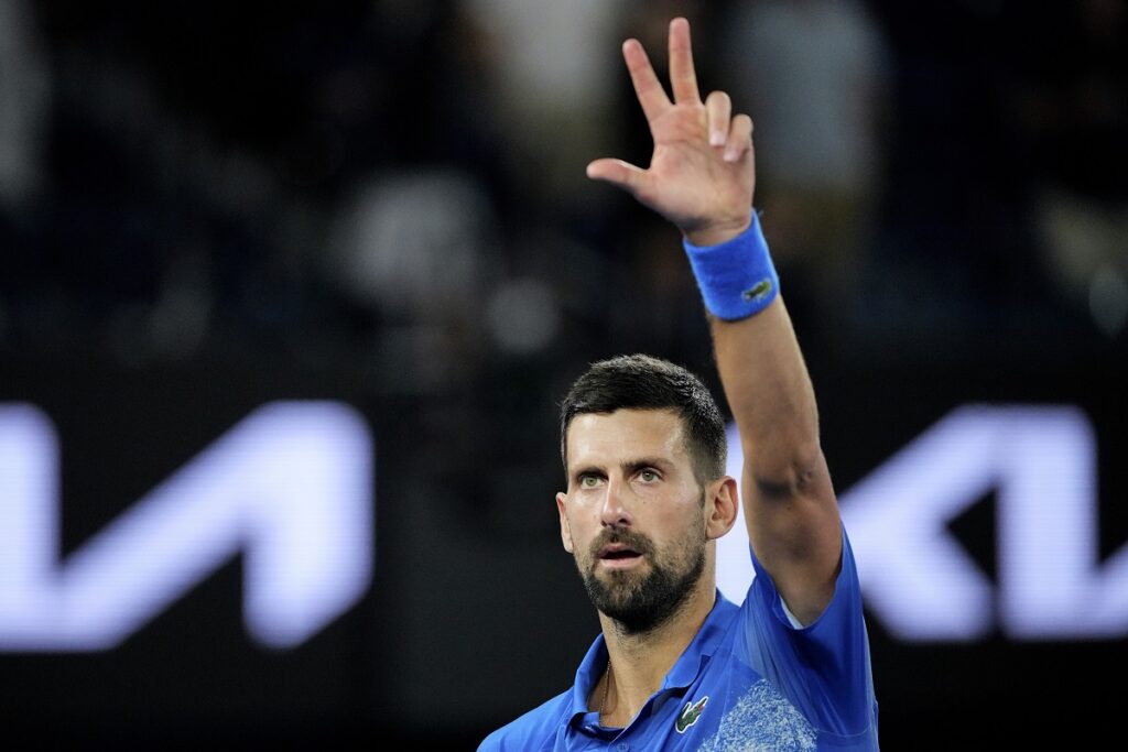 Novak Djokovic of Serbia celebrates after defeating Carlos Alcaraz of Spain in their quarterfinal match at the Australian Open tennis championship in Melbourne, Australia, Wednesday, Jan. 22, 2025. (AP Photo/Vincent Thian)