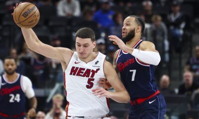 Los Angeles Clippers guard Amir Coffey (7) defends against Miami Heat forward Nikola Jovic (5) during the second half of an NBA basketball game, Monday, Jan. 13, 2025, in Los Angeles. (AP Photo/Jessie Alcheh)