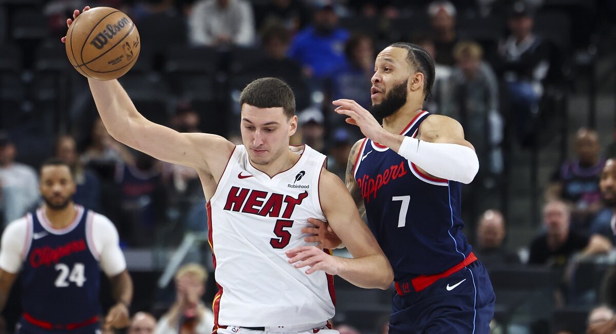 Los Angeles Clippers guard Amir Coffey (7) defends against Miami Heat forward Nikola Jovic (5) during the second half of an NBA basketball game, Monday, Jan. 13, 2025, in Los Angeles. (AP Photo/Jessie Alcheh)