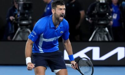 Novak Djokovic of Serbia celebrates after defeating Carlos Alcaraz of Spain in their quarterfinal match at the Australian Open tennis championship in Melbourne, Australia, Wednesday, Jan. 22, 2025. (AP Photo/Asanka Brendon Ratnayake)