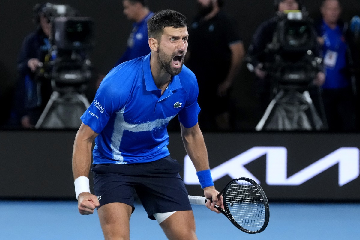 Novak Djokovic of Serbia celebrates after defeating Carlos Alcaraz of Spain in their quarterfinal match at the Australian Open tennis championship in Melbourne, Australia, Wednesday, Jan. 22, 2025. (AP Photo/Asanka Brendon Ratnayake)