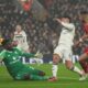 Liverpool's Cody Gakpo, right, Manchester United's Lisandro Martinez, center, and goalkeeper Andre Onana battle for the ball during the English Premier League soccer match at the Anfield stadium in Liverpool, England, Sunday, Jan. 5, 2025. (AP Photo/Jon Super)