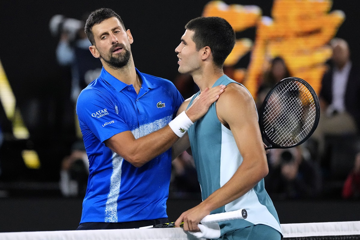 Novak Djokovic, left, of Serbia, is congratulated by Carlos Alcaraz of Spain following their quarterfinal match at the Australian Open tennis championship in Melbourne, Australia, Wednesday, Jan. 22, 2025. (AP Photo/Vincent Thian)