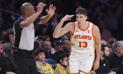 Atlanta Hawks guard Bogdan Bogdanovic, right, gestures after scoring during the first half of an NBA basketball game against the Los Angeles Lakers, Friday, Jan. 3, 2025, in Los Angeles. (AP Photo/Mark J. Terrill)