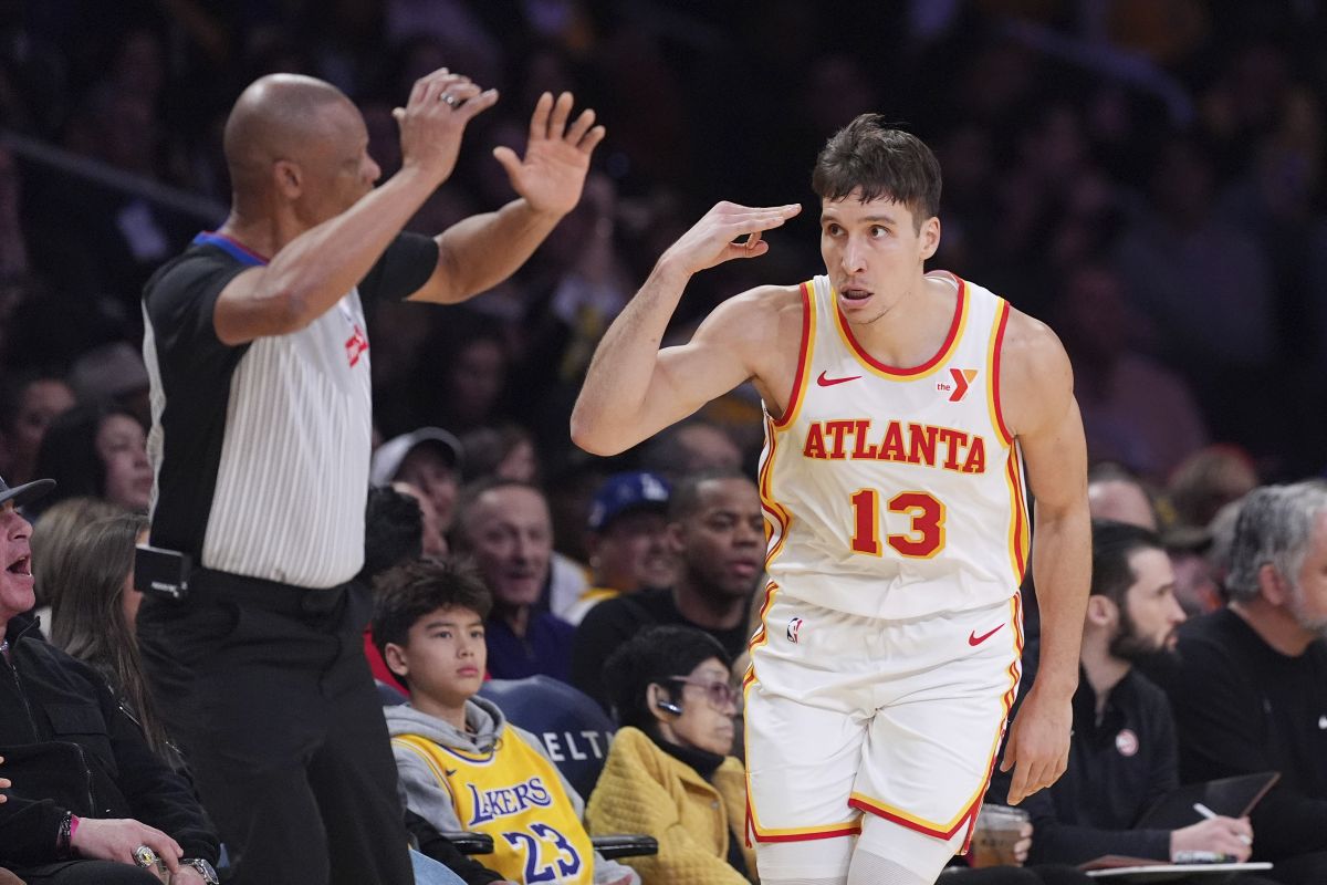 Atlanta Hawks guard Bogdan Bogdanovic, right, gestures after scoring during the first half of an NBA basketball game against the Los Angeles Lakers, Friday, Jan. 3, 2025, in Los Angeles. (AP Photo/Mark J. Terrill)