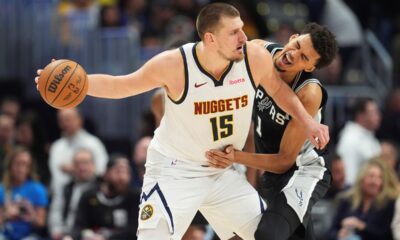 Denver Nuggets center Nikola Jokic, looks to pass the ball as San Antonio Spurs center Victor Wembanyama defends in the second half of an NBA basketball game Friday, Jan. 3, 2025, in Denver. (AP Photo/David Zalubowski)