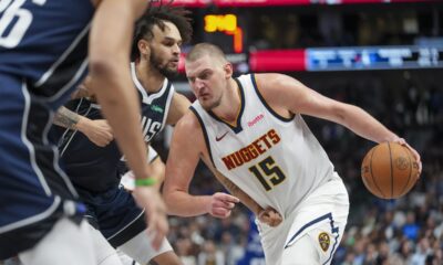 Denver Nuggets center Nikola Jokic (15) drives against Dallas Mavericks center Dereck Lively II during the second half of an NBA basketball game, Sunday, Jan. 12, 2025, in Dallas. The Nuggets won 112-101. (AP Photo/Julio Cortez)