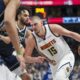 Denver Nuggets center Nikola Jokic (15) drives against Dallas Mavericks center Dereck Lively II during the second half of an NBA basketball game, Sunday, Jan. 12, 2025, in Dallas. The Nuggets won 112-101. (AP Photo/Julio Cortez)