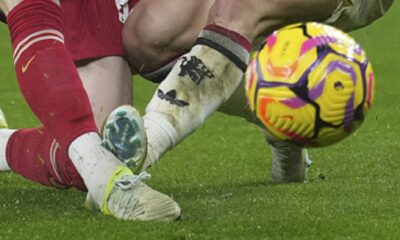 Manchester United's Alejandro Garnacho, right, and Liverpool's Diogo Jota fight for the ball during the English Premier League soccer match at the Anfield stadium in Liverpool, England, Sunday, Jan. 5, 2025. (AP Photo/Jon Super)