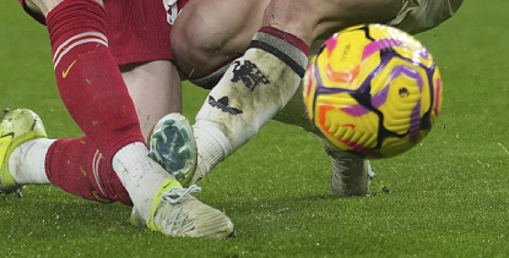 Manchester United's Alejandro Garnacho, right, and Liverpool's Diogo Jota fight for the ball during the English Premier League soccer match at the Anfield stadium in Liverpool, England, Sunday, Jan. 5, 2025. (AP Photo/Jon Super)