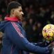 Manchester United's Marcus Rashford holds the ball during the warm up before the English Premier League soccer match between Manchester United and Newcastle at the Old Trafford stadium in Manchester, England, Monday, Dec. 30, 2024. (AP Photo/Dave Thompson)