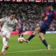 Real Madrid's Lucas Vazquez, left, challenges for the ball with Barcelona's Pedri during the Spain Super Cup final soccer match between Real Madrid and Barcelona at King Abdullah Stadium in Jeddah, Saudi Arabia, Sunday, Jan. 12, 2025. (AP Photo/Altaf Qadri)