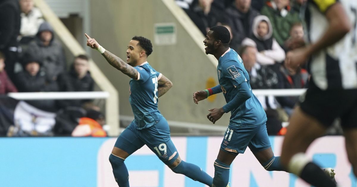 Bournemouth's Justin Kluivert, left, celebrates after scoring his side's third goal during the English Premier League soccer match between Newcastle United and AFC Bournemouth in Newcastle upon Tyne, England, Saturday, Jan. 18, 2025. (Owen Humphreys/PA via AP)