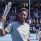 Gael Monfils of France holds up the trophy after defeating Zizou Bergs of Belgium to win the men's singles of the ASB Classic tennis tournament at Manuka Doctor Arena in Auckland, New Zealand, Saturday, Jan. 11, 2025. (David Rowland/Photosport via AP)