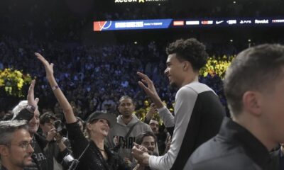 San Antonio Spurs center Victor Wembanyama, middle right, celebrates with fans after a Paris Games 2025 NBA basketball game between the Indiana Pacers and the Spurs in Paris, Thursday, Jan. 23, 2025. (AP Photo/Thibault Camus)