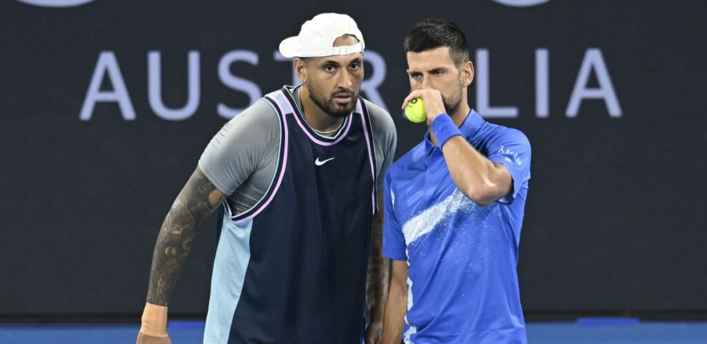 Australia's Nick Kyrgios, left, talks with Serbia's Novak Djokovic during their doubles match against Alexander Erler of Austria and Andreas Mies of Germany in the Brisbane International, at the Queensland Tennis Centre in Brisbane, Australia, Monday, Dec. 30, 2024. (Darren England/AAP Image via AP)