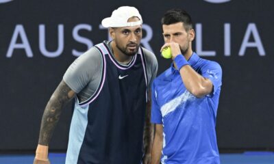 Australia's Nick Kyrgios, left, talks with Serbia's Novak Djokovic during their doubles match against Alexander Erler of Austria and Andreas Mies of Germany in the Brisbane International, at the Queensland Tennis Centre in Brisbane, Australia, Monday, Dec. 30, 2024. (Darren England/AAP Image via AP)