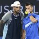 Australia's Nick Kyrgios, left, talks with Serbia's Novak Djokovic during their doubles match against Alexander Erler of Austria and Andreas Mies of Germany in the Brisbane International, at the Queensland Tennis Centre in Brisbane, Australia, Monday, Dec. 30, 2024. (Darren England/AAP Image via AP)