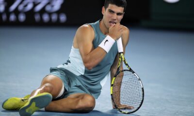 Carlos Alcaraz of Spain reacts following a fall during his quarterfinal match against Novak Djokovic of Serbia at the Australian Open tennis championship in Melbourne, Australia, early Wednesday, Jan. 22, 2025. (AP Photo/Vincent Thian)