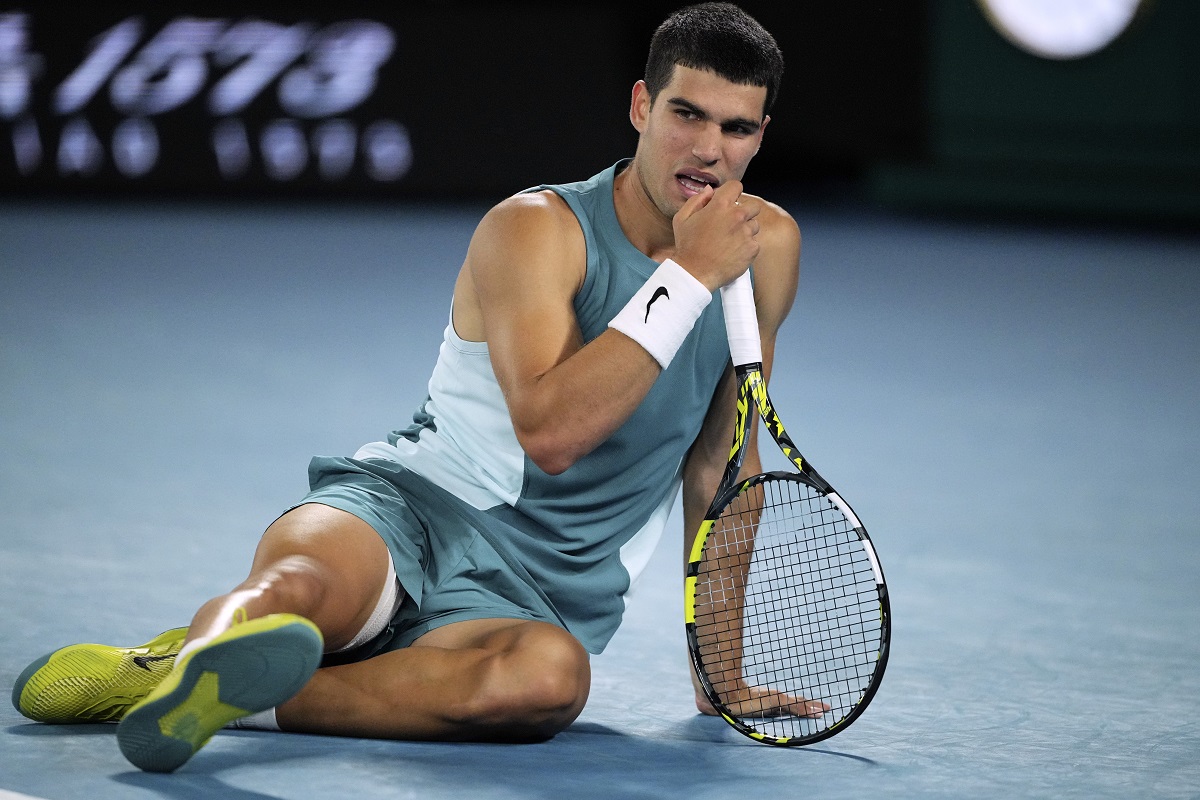 Carlos Alcaraz of Spain reacts following a fall during his quarterfinal match against Novak Djokovic of Serbia at the Australian Open tennis championship in Melbourne, Australia, early Wednesday, Jan. 22, 2025. (AP Photo/Vincent Thian)