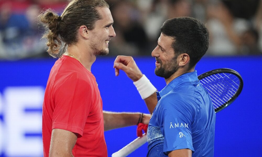 Serbia's Novak Djokovic, right, is congratulated by Germany's Alexander Zverev following their exhibition match ahead of the Australian Open tennis championship in Melbourne, Australia, Thursday, Jan. 9, 2025. (AP Photo/Vincent Thian)