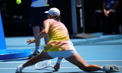 Iga Swiatek of Poland plays a forehand return to Emma Navarro of the U.S. during their quarterfinal match at the Australian Open tennis championship in Melbourne, Australia, Wednesday, Jan. 22, 2025. (AP Photo/Vincent Thian)