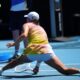 Iga Swiatek of Poland plays a forehand return to Emma Navarro of the U.S. during their quarterfinal match at the Australian Open tennis championship in Melbourne, Australia, Wednesday, Jan. 22, 2025. (AP Photo/Vincent Thian)