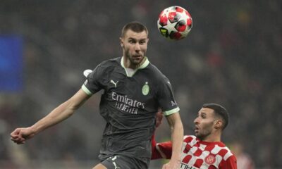 AC Milan's Strahinja Pavlovic, left, jumps above Girona's Abel Ruiz during the Champions League opening phase soccer match between AC Milan and Girona at the San Siro stadium in Milan, Italy, Wednesday, Jan. 22, 2025. (AP Photo/Antonio Calanni)