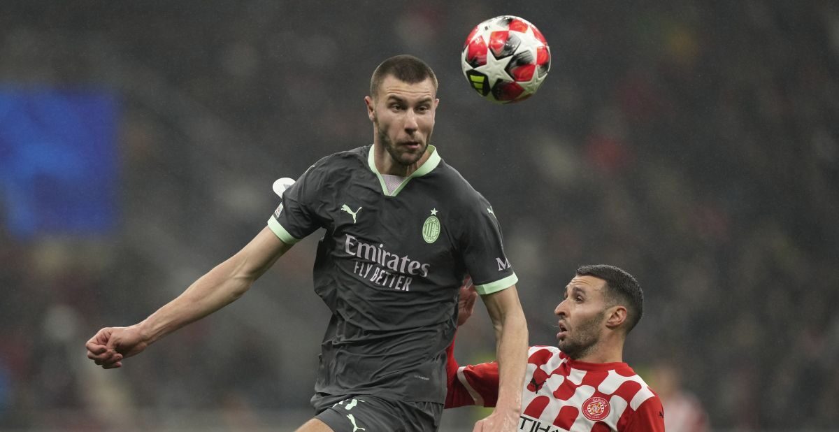 AC Milan's Strahinja Pavlovic, left, jumps above Girona's Abel Ruiz during the Champions League opening phase soccer match between AC Milan and Girona at the San Siro stadium in Milan, Italy, Wednesday, Jan. 22, 2025. (AP Photo/Antonio Calanni)