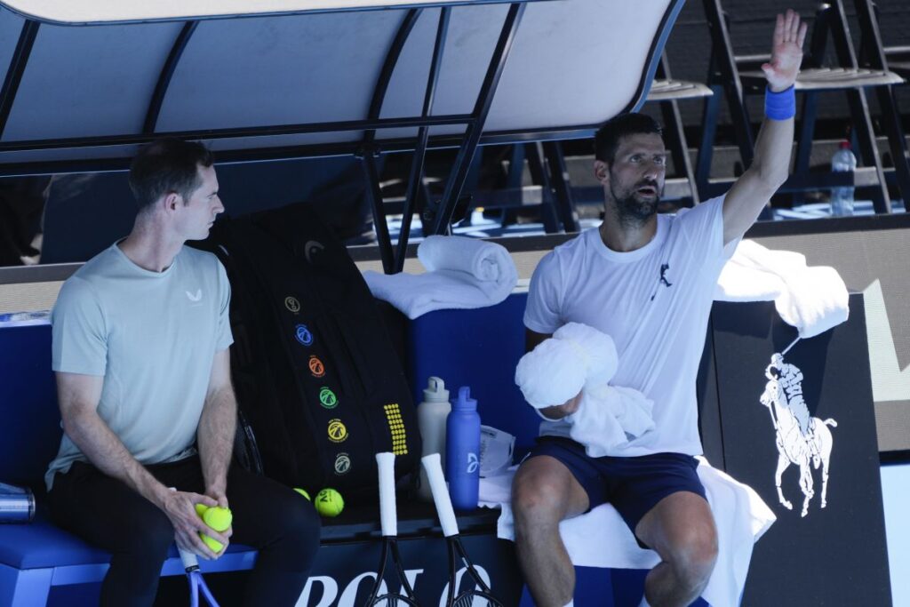 Serbia's Novak Djokovic talks with his coach Andy Murray, left, during a practice session ahead of the Australian Open tennis championship in Melbourne, Australia, Saturday, Jan. 11, 2025. (AP Photo/Ng Han Guan)