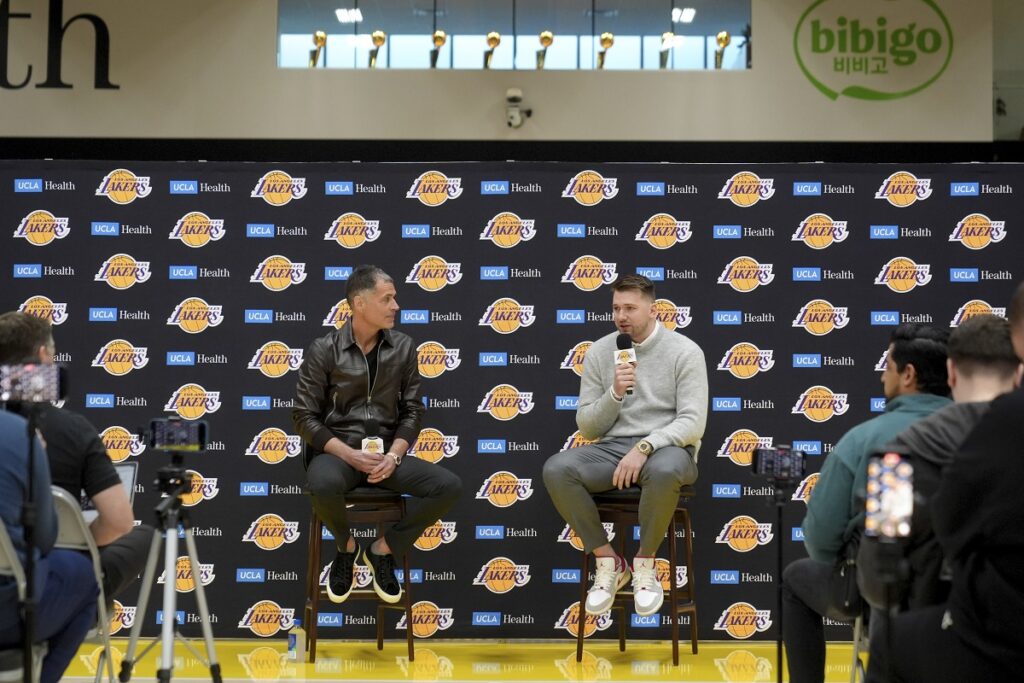 Los Angeles Lakers' Luka Doncic speaks next to general manager Rob Pelinka during an introductory NBA basketball press conference Tuesday, Feb. 4, 2025, in El Segundo, Calif. (AP Photo/Jae C. Hong)