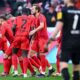 Bayern's Harry Kane, centre, celebrates after scoring his side's third goal during the German Bundesliga soccer match between Bayern Munich and Holstein Kiel at the Allianz Arena in Munich, Germany, Saturday, Feb. 1, 2025 (Sven Hoppe/dpa via AP)