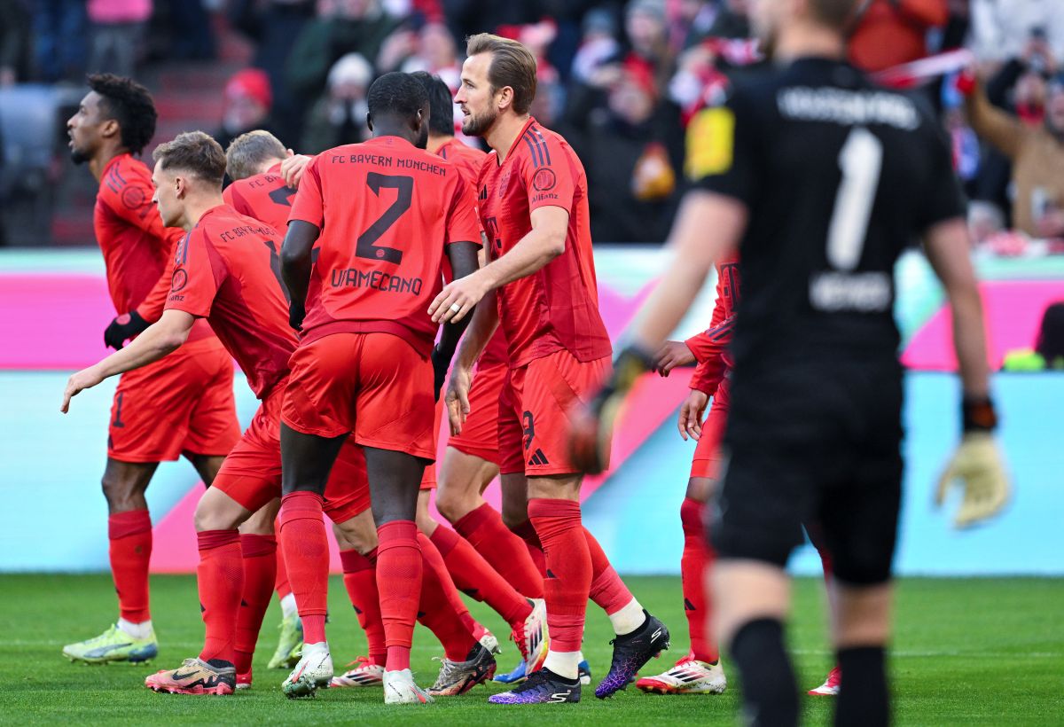 Bayern's Harry Kane, centre, celebrates after scoring his side's third goal during the German Bundesliga soccer match between Bayern Munich and Holstein Kiel at the Allianz Arena in Munich, Germany, Saturday, Feb. 1, 2025 (Sven Hoppe/dpa via AP)