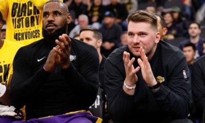 Los Angeles Lakers guard Luka Doncic, right, sits next to forward LeBron James on the bench before an NBA basketball game against the Los Angeles Clippers, Tuesday, Feb. 4, 2025, in Inglewood, Calif. (AP Photo/Kevork Djansezian)