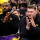 Los Angeles Lakers guard Luka Doncic, right, sits next to forward LeBron James on the bench before an NBA basketball game against the Los Angeles Clippers, Tuesday, Feb. 4, 2025, in Inglewood, Calif. (AP Photo/Kevork Djansezian)