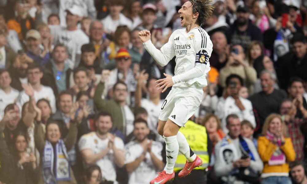 Real Madrid's Luka Modric celebrates after scoring the opening goal during the Spanish La Liga soccer match between Real Madrid and Girona at the Santiago Bernabeu stadium in Madrid, Spain, Sunday, Feb. 23, 2025. (AP Photo/Manu Fernandez)