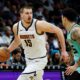 Denver Nuggets center Nikola Jokic (15) brings the ball up court against Charlotte Hornets guard KJ Simpson during the second half of an NBA basketball game in Charlotte, N.C., Saturday, Feb. 1, 2025. (AP Photo/Nell Redmond)