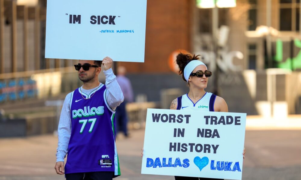 Ryan Safdarinia, left, and Lillian McCall hold signs reacting to the news that the Dallas Mavericks traded Luka Doncic to the Los Angeles Lakers outside the American Airlines Center, Sunday, Feb. 2, 2025, in Dallas. (Elias Valverde II/The Dallas Morning News via AP)